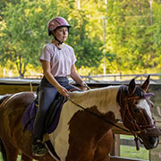 a rider on a horse at Faith Equestrian Therapeutic Center